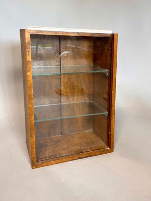 wooden display case with glass shelves on a white background