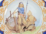 a plate with a picture of a man on a boat