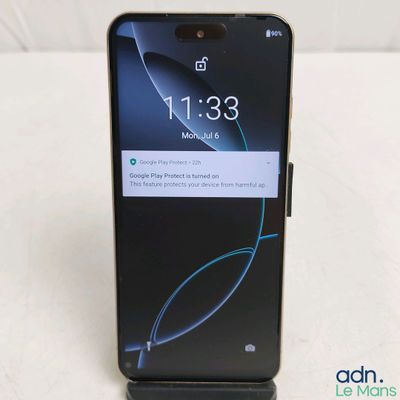 a close up of the back of a black phone on a white surface