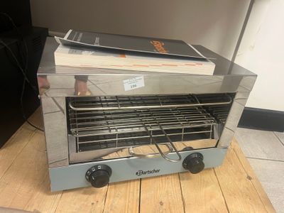 a toaster oven sitting on top of a wooden table