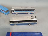 four toy buses that are sitting next to each other