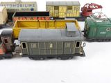 several toy trains are lined up in a row on a white surface