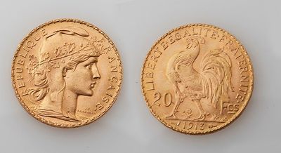 two gold sovereigns, one of which is a woman and one of which is a man