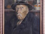 portrait of an old man in a hat and coat in a wooden frame