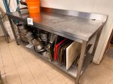 a stainless steel table with a bunch of pots and pans on it