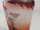 a vase that has a brown and white design on it