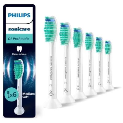 six brosses à dents alignées en rang devant un emballage