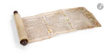 an old scroll with writing on it sitting on a white surface