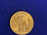 a close up of a gold coin on a blue surface