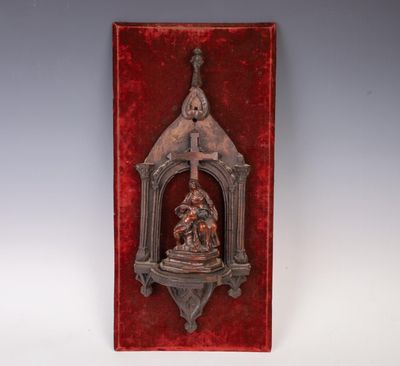an image of a metal plaque with a statue on it
