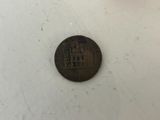 a close up of a coin on a table with a white background