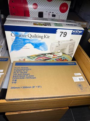 two boxes of quilting kits on a table