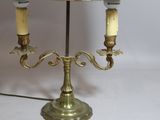 a lamp that is sitting on a table with two candles on it