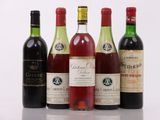 several bottles of wine are lined up on a table