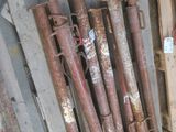 a pile of old rusty pipes in a storage area