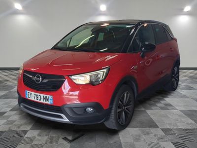 a red opel suv parked in a garage with a checkered floor