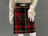 an image of a mannequin dressed in a white shirt and plaid skirt
