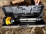 a person holding a tool in a case on the ground