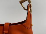 a close up of a brown purse with a gold handle