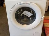 a washing machine that is sitting in the middle of a room