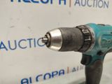 a drill that is sitting on a table in front of a sign