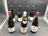 several bottles of wine are lined up in a row on a counter