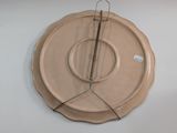 a clock that is hanging on the wall next to a plate