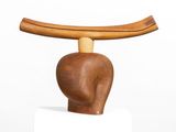 a wooden sculpture of a man ' s head on top of a table