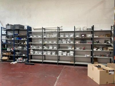 a large room with many shelves and bins on it