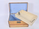 a small wooden box with a lid on a white surface
