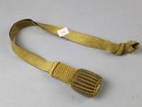 an image of a gold belt with a metal buckle on a white surface