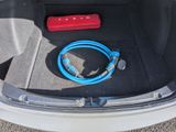 a blue hose in the trunk of a car