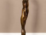 bronze statue of a man standing on a black base