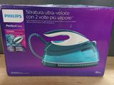 the box of a blue and white steam iron sitting on a table
