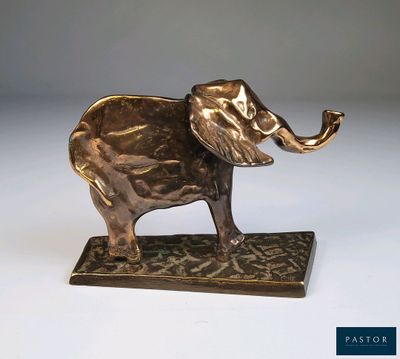 une image représentant une statue d'éléphant tenant une pipe dans sa trompe