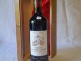 a bottle of wine in a wooden box on a table