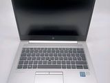 an open laptop computer sitting on top of a white table
