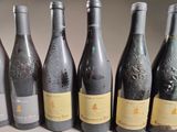 six bottles of wine are lined up in a row on a table