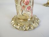 a glass vase with a floral design on it on a table
