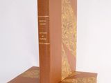 two books sitting on top of each other on a white surface