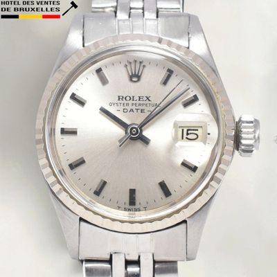 a close up of a watch on a table with a white background