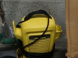 a yellow blower sitting on the floor next to a cardboard box