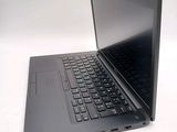 a laptop with a black keyboard on a white surface