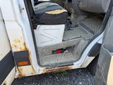 a white van with a trash can in the back of it