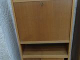two wooden cabinets next to each other on the floor