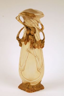 a glass vase with a bird on top of it
