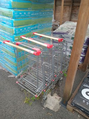 many shopping carts that are stacked up on the street