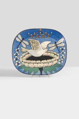 a small plate with a bird on it on a table