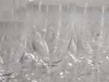 many wine glasses lined up on a table