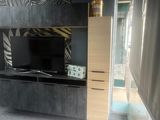 a television on the entertainment center in the living room